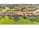 Aerial view showcasing neighborhood with lush landscaping, tile roofs, and community features at 3980 Sunset Lake Dr, Lakeland, FL 33810