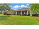 Manicured backyard featuring lush lawn, screened patio and well-maintained landscaping at 3980 Sunset Lake Dr, Lakeland, FL 33810