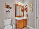 Cozy bathroom with custom mirror, cabinet and neutral paint, and a floral arrangement for decor at 3980 Sunset Lake Dr, Lakeland, FL 33810