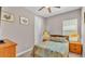 Comfortable bedroom with natural light from the window and vintage decor and artwork at 3980 Sunset Lake Dr, Lakeland, FL 33810