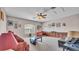 Spacious bonus room with built-in storage, ceiling fan and multiple seating areas at 3980 Sunset Lake Dr, Lakeland, FL 33810