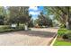 A welcoming community entrance features brick-paved lanes, manicured landscaping, and controlled access points at 3980 Sunset Lake Dr, Lakeland, FL 33810
