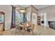 Dining room with high ceilings, an elegant chandelier and large windows with beautiful flowing curtains at 3980 Sunset Lake Dr, Lakeland, FL 33810