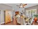 Dining room leading to the kitchen features wood floors, a wooden cabinet, and seating for six at 3980 Sunset Lake Dr, Lakeland, FL 33810