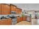 Open concept kitchen features stainless appliances, tile backsplash and wood cabinetry, and open floorplan at 3980 Sunset Lake Dr, Lakeland, FL 33810