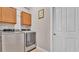 Clean laundry room features a side-by-side washer and dryer plus storage cabinets at 3980 Sunset Lake Dr, Lakeland, FL 33810