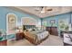 This main bedroom is a spacious retreat with an elegant tray ceiling and two dressers at 3980 Sunset Lake Dr, Lakeland, FL 33810