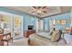 Well-lit main bedroom with light blue walls, balcony access, and tray ceiling with ceiling fan at 3980 Sunset Lake Dr, Lakeland, FL 33810