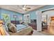 Bright main bedroom with access to the backyard featuring a king-sized bed and wooden dressers at 3980 Sunset Lake Dr, Lakeland, FL 33810