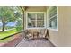 Cozy screened patio with comfortable swivel chairs and serene backyard view at 3980 Sunset Lake Dr, Lakeland, FL 33810