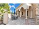 Exterior patio seating area offers a relaxing ambiance with its arched columns and blue umbrellas at 3980 Sunset Lake Dr, Lakeland, FL 33810