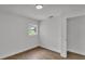 This bedroom features wood-look floors, white walls, and a window at 408 Sycamore Sw St, Fort Meade, FL 33841
