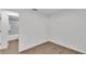 This bedroom features wood-look floors, white walls, and an ensuite bathroom at 408 Sycamore Sw St, Fort Meade, FL 33841