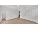 An airy bedroom featuring new light wood floors, ample closet space, and fresh, neutral paint at 408 Sycamore Sw St, Fort Meade, FL 33841