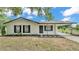 Charming home with a new landscape, fresh white paint and contrasting black trim and a carport at 408 Sycamore Sw St, Fort Meade, FL 33841