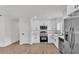 A well-lit kitchen featuring stainless steel appliances, ample counter space, and pristine white cabinetry at 408 Sycamore Sw St, Fort Meade, FL 33841