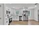 Beautifully updated kitchen features stainless steel appliances, white cabinets and luxury vinyl floors at 408 Sycamore Sw St, Fort Meade, FL 33841