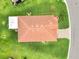 An aerial of a house with a red tiled roof, brick driveway and green surroundings at 4125 Prima Lago Cir, Lakeland, FL 33810