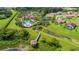 Aerial view of a community with a pool, walking paths, and lush green spaces at 4125 Prima Lago Cir, Lakeland, FL 33810