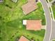 A bird's eye view of a home with a tile roof and a well-kept lawn in a suburban setting at 4125 Prima Lago Cir, Lakeland, FL 33810
