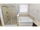This bathroom has a shower and a separate soaking tub at 4125 Prima Lago Cir, Lakeland, FL 33810