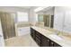 The bathroom has a shower, soaking tub, granite counters and double sinks at 4125 Prima Lago Cir, Lakeland, FL 33810