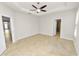 Spacious bedroom features neutral paint, tiled floors, and a ceiling fan at 4125 Prima Lago Cir, Lakeland, FL 33810