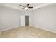 The bright bedroom with neutral paint and tiled floors has a ceiling fan at 4125 Prima Lago Cir, Lakeland, FL 33810