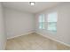 Tiled bedroom has two windows with backyard views and neutral paint at 4125 Prima Lago Cir, Lakeland, FL 33810