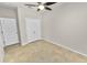Neutral bedroom with tile flooring, ceiling fan, closet, and white trim at 4125 Prima Lago Cir, Lakeland, FL 33810
