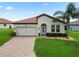 Attractive single-story home with a well-kept lawn and a tiled roof at 4125 Prima Lago Cir, Lakeland, FL 33810