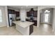 Spacious kitchen with dark wood cabinets, granite countertops, stainless steel appliances, and a kitchen island at 4125 Prima Lago Cir, Lakeland, FL 33810