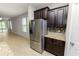 Kitchen featuring stainless steel refrigerator and dark wood cabinets at 4125 Prima Lago Cir, Lakeland, FL 33810