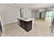 Kitchen island with stainless steel appliances and access to living room at 4125 Prima Lago Cir, Lakeland, FL 33810
