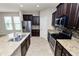 Modern kitchen featuring granite countertops, stainless steel appliances, tile backsplash, and ample cabinet space at 4125 Prima Lago Cir, Lakeland, FL 33810