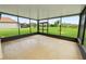 Inviting screened-in lanai with a view of the landscaped backyard and surrounding homes at 4125 Prima Lago Cir, Lakeland, FL 33810