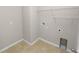 Functional laundry room with tile flooring, utility connections, and shelving at 4125 Prima Lago Cir, Lakeland, FL 33810