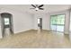 Open living room featuring tile floors, a ceiling fan, and sliding glass doors at 4125 Prima Lago Cir, Lakeland, FL 33810