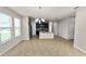 Open floor plan with living and dining areas connected to a modern kitchen at 4125 Prima Lago Cir, Lakeland, FL 33810