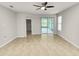 Spacious living room featuring tile flooring, neutral walls, and a sliding glass door at 4125 Prima Lago Cir, Lakeland, FL 33810