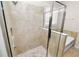 Walk in tiled shower with frameless glass door and shower niche at 4125 Prima Lago Cir, Lakeland, FL 33810