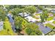A waterfront property featuring a serene canal, lush greenery, and a well-maintained home, offering a tranquil retreat at 416 Bayou Rd, Winter Haven, FL 33884