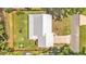 Aerial view of a single Gathering home with metal roof, backyard firepit, and proximity to water at 416 Bayou Rd, Winter Haven, FL 33884