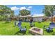 Spacious backyard with a fire pit, seating, and a well-maintained lawn at 416 Bayou Rd, Winter Haven, FL 33884