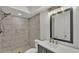 Bathroom with new marble look tiles in the shower, modern mirror and sink with new vanity at 416 Bayou Rd, Winter Haven, FL 33884