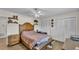 Cozy bedroom featuring wood floors, a ceiling fan, and closet with paneled doors at 416 Bayou Rd, Winter Haven, FL 33884