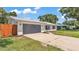 Exterior view of home with well-maintained yard, two-car garage and updated fixtures at 416 Bayou Rd, Winter Haven, FL 33884