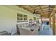 Large patio featuring covered area with a ceiling fan and wicker furniture at 416 Bayou Rd, Winter Haven, FL 33884
