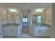 Bathroom features a double vanity with granite countertops and tiled floor at 4306 Juliana Lake Dr, Auburndale, FL 33823