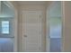 Hallway view showcasing the doors leading to the various rooms at 4306 Juliana Lake Dr, Auburndale, FL 33823